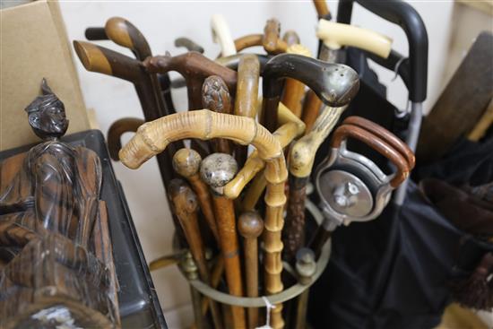 A large collection of walking sticks and umbrellas,